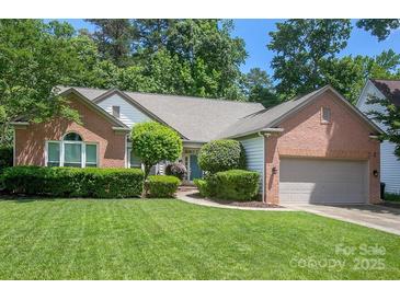 Charming brick home features a well-manicured lawn and established landscaping at 6009 Swanston Dr, Charlotte, NC 28269