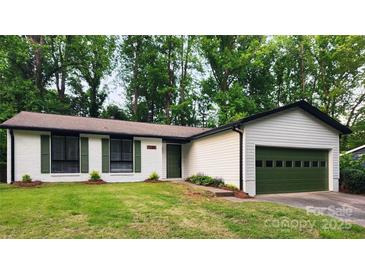 Charming single-story home with a well-manicured lawn and a two-car garage at 7228 Rollingridge Dr, Charlotte, NC 28211