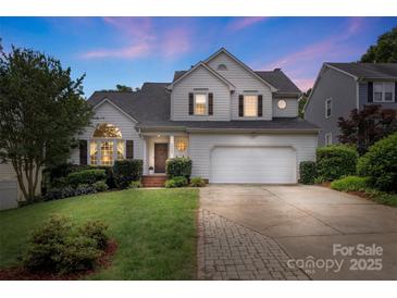 Charming two-story home featuring a manicured front lawn, inviting entrance, and attached two-car garage at 8605 Tamarron Dr, Charlotte, NC 28277