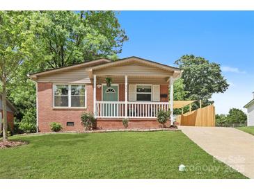 Charming brick home with a well-manicured lawn, inviting front porch, and lovely curb appeal at 906 Eastwood Dr, Rock Hill, SC 29730
