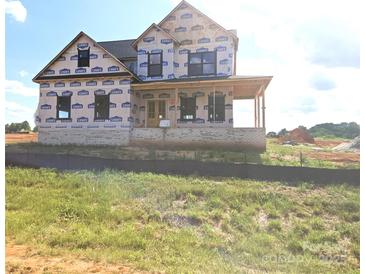 New home construction featuring brick foundation and covered porch awaiting finishing touches at Lot 100 Coppergate Dr, Salisbury, NC 28147