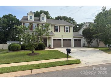 Inviting two-story home featuring a three-car garage and well-manicured lawn at 12517 Pine Terrace Ct, Charlotte, NC 28273