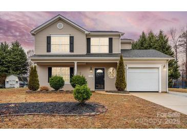 Lovely two-story home with a manicured lawn, mature trees, and an attached garage at 130 Valley Glen Dr, Troutman, NC 28166