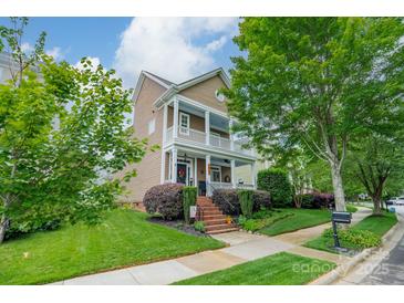 Charming two-story home with a welcoming porch and beautifully landscaped front yard, blending classic charm with modern curb appeal at 16425 Spruell St, Huntersville, NC 28078