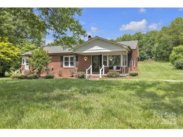 Charming brick home with a cozy front porch and beautifully landscaped front yard at 1770 Nc 90 W Hwy, Taylorsville, NC 28681