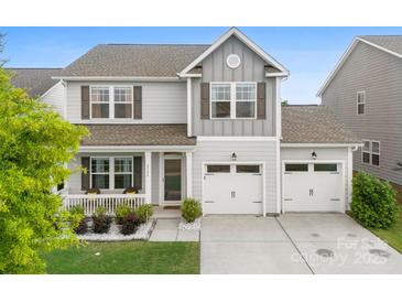 Charming two-story home featuring a welcoming front porch and a two-car garage at 2104 New Hope Branch Way, Belmont, NC 28012