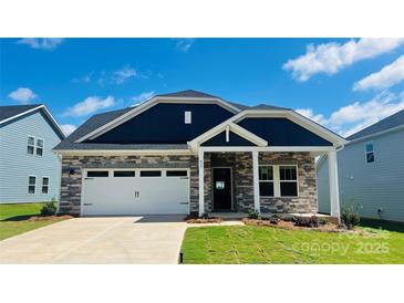 Beautiful single-Gathering home featuring stone accents, a two-car garage, and a well-manicured front yard at 417 Bent Burr Crk, York, SC 29745