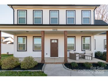 Charming two-story home featuring a covered porch with wooden columns and a landscaped front yard at 5413 Austin Rd # 4, Monroe, NC 28112