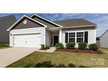 Charming single-story home featuring a two-car garage, well-maintained lawn and attractive landscaping at 7315 Amberly Hills Rd, Charlotte, NC 28215