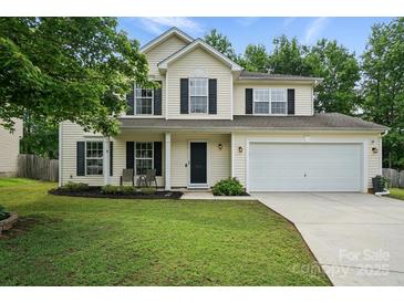 Inviting two-story home features a well-manicured lawn, attached garage, and classic design elements at 8381 Chatsworth Dr, Indian Land, SC 29707