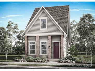 Charming two-story home featuring a cozy front porch and landscaped yard, showcasing a blend of traditional and modern design elements at 9105 Maybry Park St # Lot 114, Charlotte, NC 28212