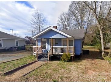 Charming one-story home featuring a cozy front porch and a classic blue exterior at 926 Cantwell St, Charlotte, NC 28208