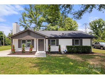 Charming single-story home with a painted brick facade, dark shutters, and a manicured front lawn at 1067 Winchester Dr, Rock Hill, SC 29730