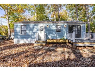Charming light blue home with a small deck and mature trees in a peaceful setting at 108 Sailors Ct # 108 B, Mount Gilead, NC 27306