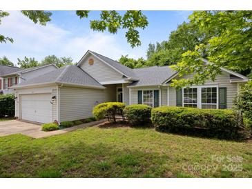 Charming home with manicured lawn and mature landscaping at 1321 Land Grant Rd, Charlotte, NC 28217