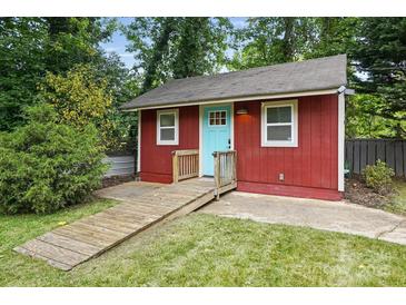 Cozy backyard studio with red siding, a bright blue door, and a convenient ramp at 4235 Howie Cir, Charlotte, NC 28205