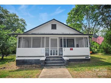 Charming home featuring a screened porch, offering a cozy and inviting outdoor living space at 514 S Martin St, Shelby, NC 28150