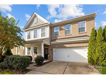 Charming two-story home with a brick and vinyl exterior, featuring an attached two-car garage at 6119 Castlecove Rd, Charlotte, NC 28278