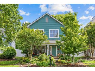 Charming two-story home featuring a landscaped yard and inviting curb appeal on a beautiful sunny day at 6827 Dunton St, Huntersville, NC 28078