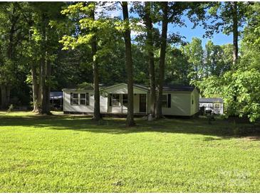 Charming single story home with a covered porch and large yard surrounded by mature trees at 850 Meadowbend Dr, York, SC 29745
