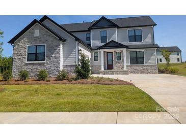 Beautiful two-story home with stone and siding, complemented by a lush green lawn at 2092 Fordhill St, Rock Hill, SC 29732