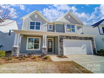 Two-story home with gray siding, stone accents, covered porch, and a two-car garage at 2233 Tabor Rd # 586, Sherrills Ford, NC 28673