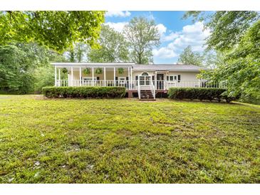Charming ranch-style home featuring a lovely porch and lush, green landscaping at 3716 Hamilton Dr, Gastonia, NC 28052