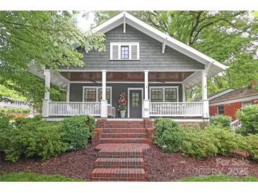 Charming home with a welcoming front porch, manicured landscaping, and classic details at 501 E Tremont Ave, Charlotte, NC 28203