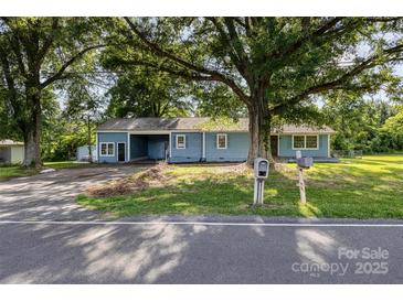 Charming blue single story home with mature trees and a welcoming front yard at 875 Marys Grove Rd, Cherryville, NC 28021