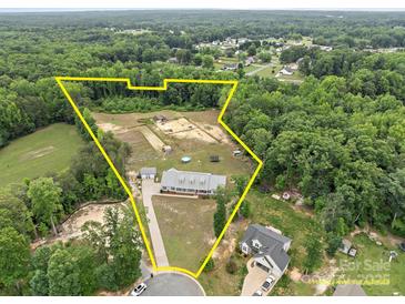Expansive property with a beautiful home, pastures, and wooded areas all within defined yellow borders at 1230 Long Creek Ln, Salisbury, NC 28146