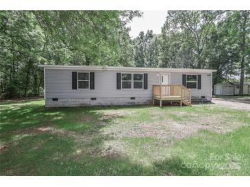Charming single-story home with a gray exterior, black shutters, and a wooden porch at 1380 St. Johns Church Rd, Concord, NC 28025