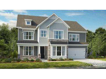 Charming two-story home with stone accents, gray siding, and a well-manicured front lawn at 162 Nicholson Ln, Mooresville, NC 28115