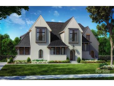 Charming two-story home featuring a white brick facade, multiple gables, and a professionally landscaped yard at 2C Ventosa Dr, Denver, NC 28037