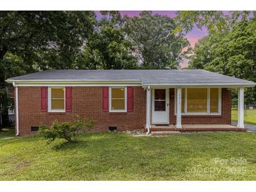 Charming brick ranch home with red shutters, green lawn, and mature trees at 4915 Galax Dr, Charlotte, NC 28213