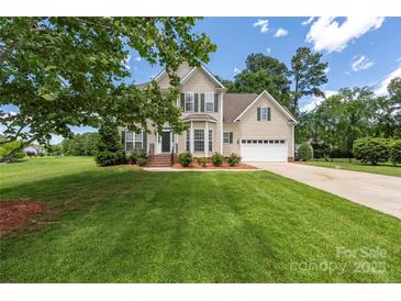 Charming two-story home with manicured lawn, attached two-car garage and classic colonial-style shutters and trim at 6504 Sybil Ct, Indian Trail, NC 28079