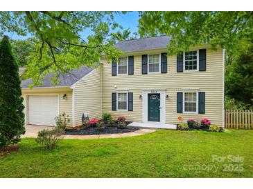 Charming two-story home featuring a well-manicured lawn and attached two-car garage at 8014 Sherington Way, Charlotte, NC 28227