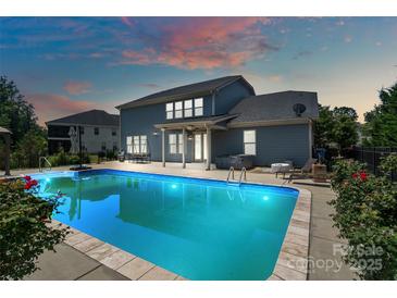 Inviting backyard with a sparkling pool, patio area, and lush landscaping at 837 Tyne Dr, Fort Mill, SC 29715
