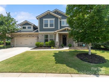 Charming two-story home featuring a manicured lawn, brick accents, and a two-car garage at 837 Tyne Dr, Fort Mill, SC 29715