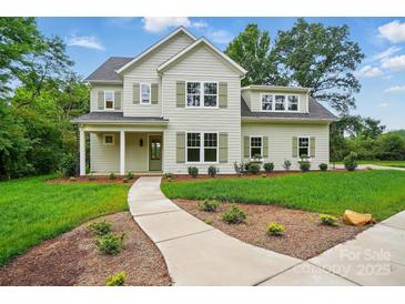 Charming two-story home with manicured lawn, beautiful landscaping, and inviting walkway at 9315 Simpson Rd, Waxhaw, NC 28173