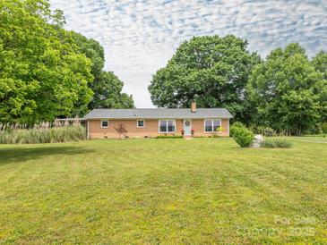 Charming brick home featuring a well-manicured front yard and inviting curb appeal at 1325 Marshville Olive Branch Rd, Marshville, NC 28103