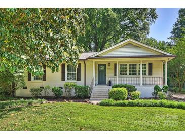 Charming brick home with a welcoming front porch and beautifully landscaped front yard at 1522 Barberry Ct, Charlotte, NC 28211