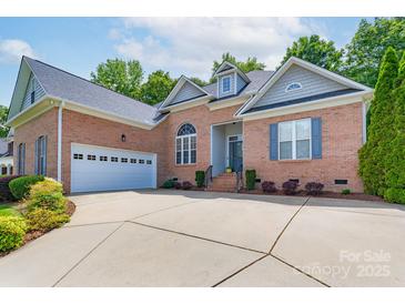 Charming brick home with an attached two-car garage and concrete driveway, complemented by tasteful landscaping at 1643 Essex Hall Dr, Rock Hill, SC 29730