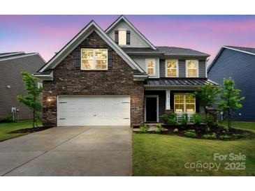 Beautiful two-story home with brick and siding, lush lawn, and two-car garage at 17812 New Mark Ave, Charlotte, NC 28278