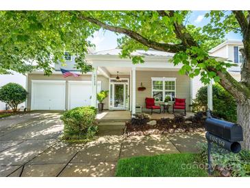Charming home featuring a covered porch with cozy seating and a two-car garage at 19539 Denae Lynn Dr, Cornelius, NC 28031