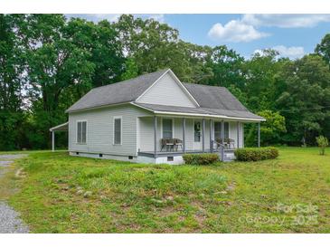 Charming home featuring a covered front porch, and lush greenery at 2126 Robby Dr, Maiden, NC 28650