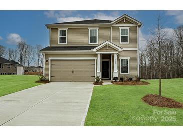 Two-story home featuring a two car garage, a well-kept lawn, and neutral siding at 2139 Rolling Hills Ct, Stanley, NC 28164