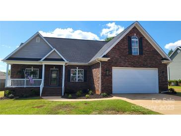 Charming brick home with a two-car garage and well-maintained landscaping in a suburban neighborhood at 3712 Travertine Dr, Lancaster, SC 29720