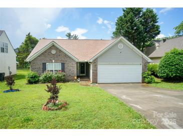 Charming brick home with an attached garage, well-manicured lawn, and inviting landscaping at 4037 Lakota Ct, Charlotte, NC 28269