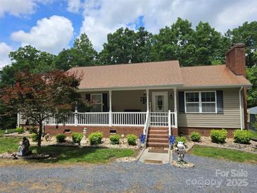 Charming single-story home featuring a welcoming front porch and beautifully landscaped front yard at 490 Deberry Rd, Mount Gilead, NC 27306