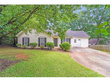 Charming single-story home with a well-maintained lawn and mature trees at 6216 Bandy Dr, Charlotte, NC 28227
